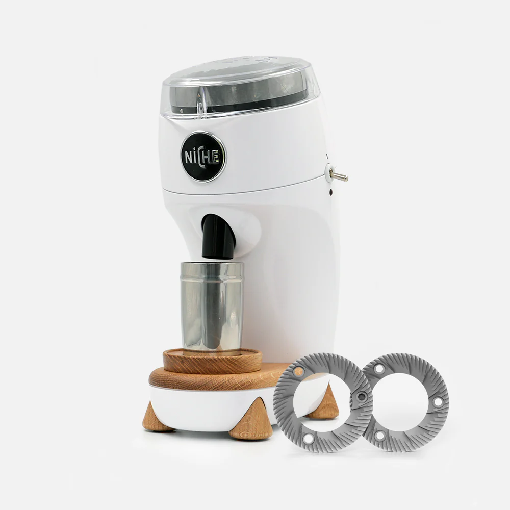 Niche Duo coffee grinder on a kitchen counter with freshly ground coffee